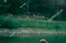 sunbathing topless coast mountain lake shutterstock attractive forest pretty woman young adult partial applied toned nudity freedom artistic filters concept