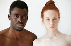 man woman african looking caucasian standing shirtless mixed race interracial couple headshot camera portrait serious young beautiful male expression people