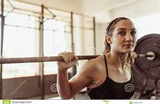 squats doing gym young female weights woman lifting barbell heavy healthy cross health club fit