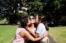 kissing friends each other loving summer girl park stocksy