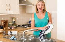 dishes washing woman kitchen sink alamy stock