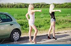 hitchhiking girls car broken blonde two sexy standing near their road stock