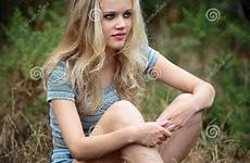 pretty teenager sitting blond stock girl teenage natural beautiful grass outdoor shorts wearing portrait bare