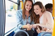 bus music two listening young women woman sharing smartphone friends post girls huawei puts strategy pressure apple
