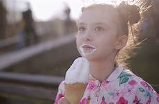 girl cream little ice licks cone eats stock bench portrait park footage