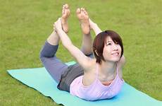 yoga japanese woman pose bow doing outdoor stock