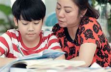 son mom teaches mother asian homework doing