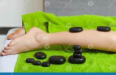 massage stones having legs woman hot feet stock