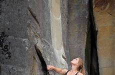female climber climbing wall rope rocky extreme river rock over stock