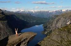 naked traveller handstands nude express performs iconic locations front upside down