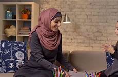 muslim mother hijab her daughter young takes hands fps laughs claps enthusiastically book