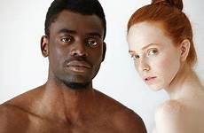 man woman young african looking redhead male caucasian studio female between mixed background camera interracial people couple race isolated posing