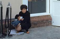 chinese poo outside tourist man boy caught tourists woman kid public doing burberry takes toilet shop dump british village twitter