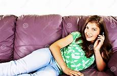 sofa girl teenage lying talking phone pretty stock