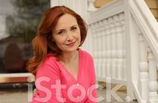 beautiful redhead older women woman sitting porch front stock premium istock freeimages getty