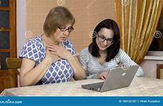 laptop mother woman teaches daughter showed open young use her old preview