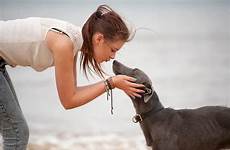 dog girl her kissing pet teenage stocksy