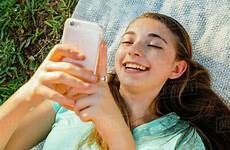 girl laughing phone texting laying cell caucasian blanket dissolve stock d145