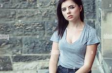 girl brunette jeans green eyes ripped beautiful shirt blue keds white toned teenager caucasian alamy portrait camera looking young