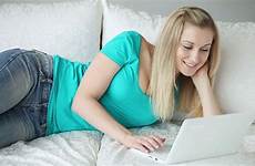 girl laptop sofa relaxing cute video smiling stock