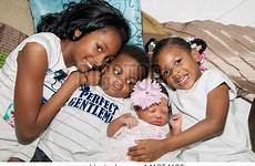 siblings african american brother sisters sister hugging baby floor two stock newborn bigstock 5pm est 9am support cuddle older portrait