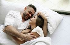 bed couple hug morning waking man beautiful loving young talk kiss while into attractive wife people