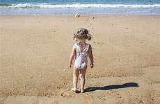 beach little girl rear playing stock crouching dissolve side water photoalto d984