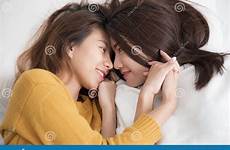 bed lesbians asian women couple catching homosexual smiling