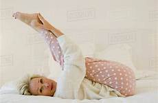 bed mature woman stretching legs lying dissolve shui zen