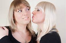 kissing blond girl cheeck brunett female stock face