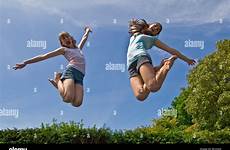 girls trampoline jumping two young yrs mid alamy air