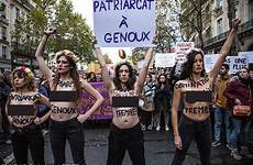 protesters tens activists violence phrases through knees trembles patriarchy placards domination bodies