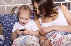 daughter bed mother watching happy tv smiling stock