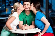 girls kissing boy two young handsome attractive restaurant stock dreamstime alamy