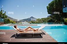 lounge sunbathing chair pool woman swimming alamy luxury next