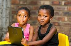tablet african kids portrait digital internet two youngsters girls playing children threesome close together learning expand will majority sad access
