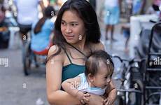 filipina girl cebu slum baby young philippines area city carries within alamy