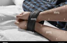 tied bed male hands belts man young alamy stock