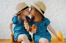 kissing twin sisters stock girls little kisses similar istock royalty