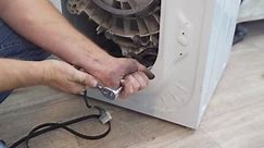 repair of household appliances at home with their own hands. the repairman repairs the washing machine. services for the repair of household appliances at home and in the workshop.