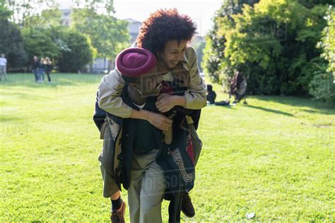 The chart shows the stock's historical price and volume. Couple playing piggyback in park, Milan, Italy - Stock ...