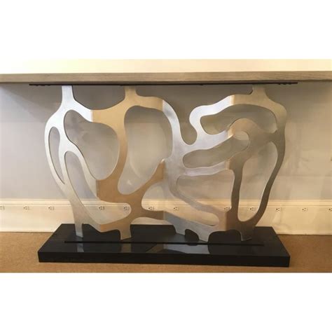 First, the artmax modern silver console table with mirror is a stylish table with a matching mirror. Ambella Home Modern Silver Metal Sculpted Console Table | Chairish