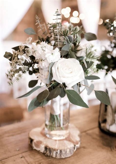 Working with wildflowers, candles, lanterns will add special romance and charm to the wedding décor. a stylish winter wedding centerpiece of white blooms ...