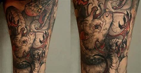 An artsy tattoo of a coiled snake. Snake and rat tattoo on the back of the right leg.