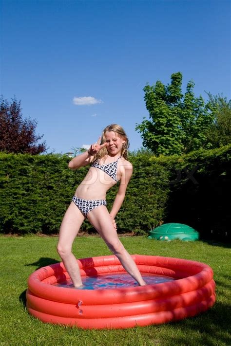 Do you want other members who are interested in having fun to find you? A teenage girl having fun on a plastic ... | Stock image ...