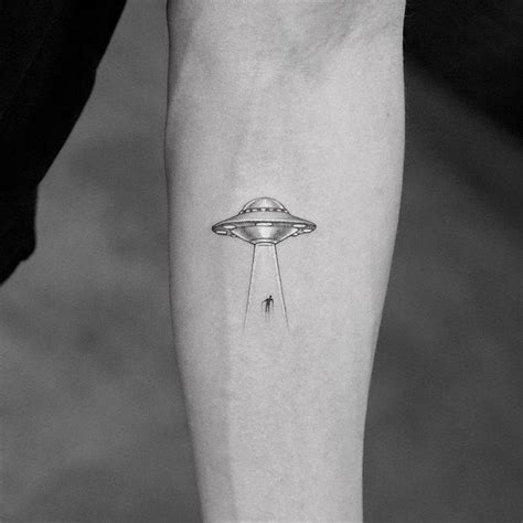 A supercool geometric design goes perfectly with this softly shaded spaceship. Single needle UFO tattoo on the left inner forearm.