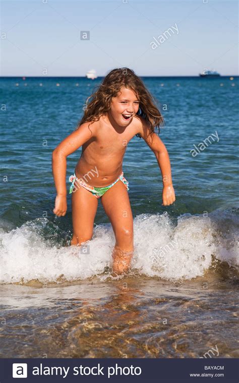 From the about us page Little girl jumping the waves Stock Photo - Alamy