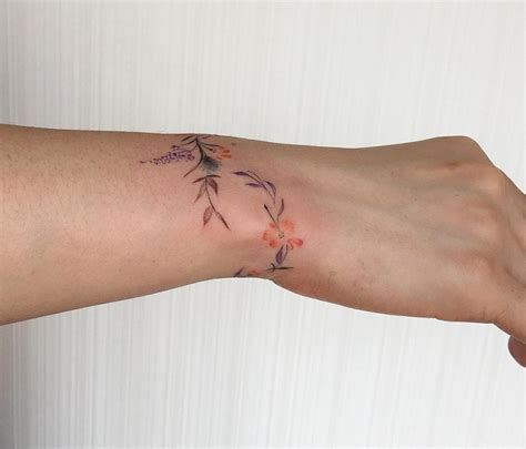 Floral tattoo bicep wrap around tattoos tattoos sleeve tattoos. 77 Deliciously Delicate Wrist Tattoos - Page 2 of 8 - TattooMagz