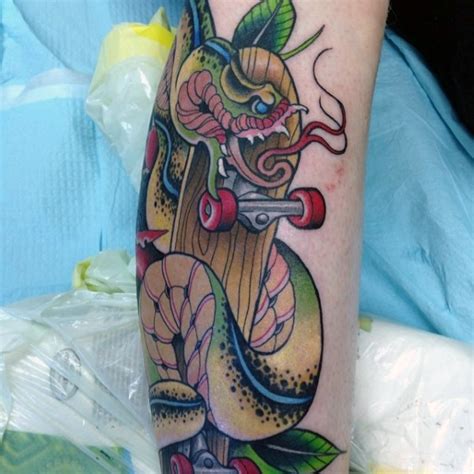 Snake tattoos positioned on one's ankle tend to be pointing up. New school style colored snake with skateboard tattoo on leg - Tattooimages.biz