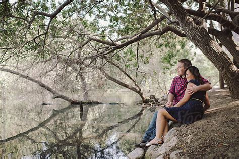 Thoughtful designs for support that puts your comfort first. Romantic couple cuddling by lake in nature by Kristin ...